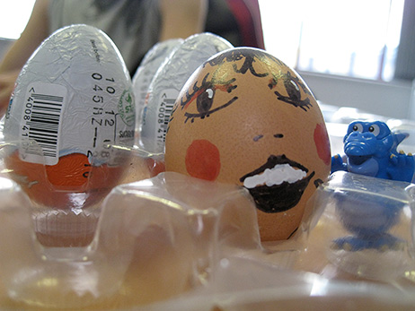 The egg, painted and ready to be dropped, together with Kinder Egg prizes for the winners.