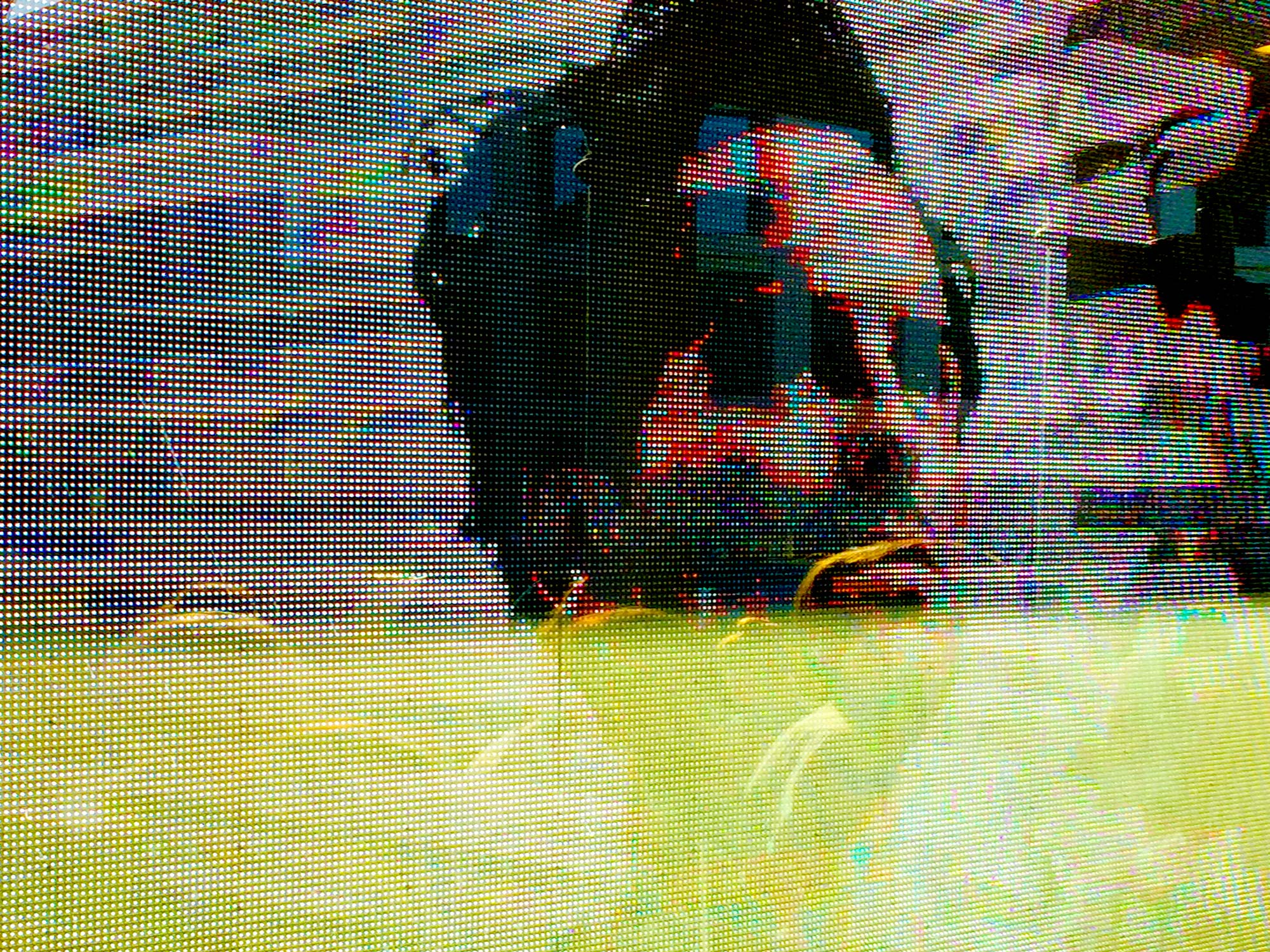 A digital screen shows the distressed image of a man's face.