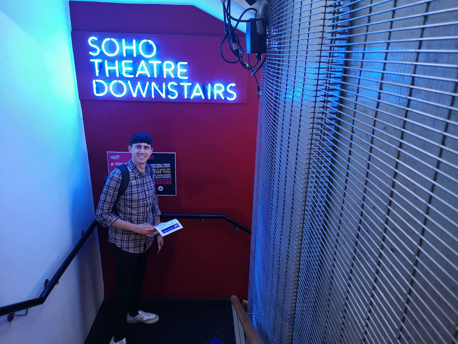 Nick from Cog poses in front of a sign that reads Soho Theatre Downstairs