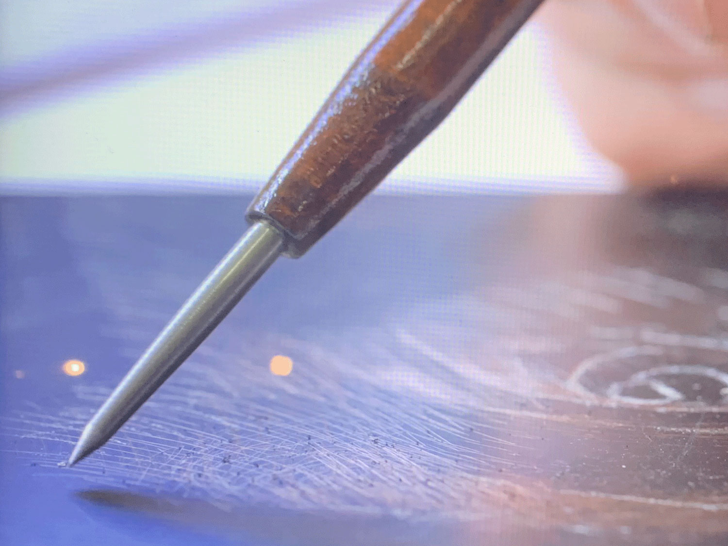 Still from a video demonstrating the process of etching and aquatint.