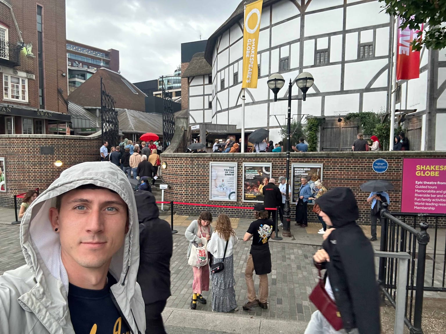 Nick poses in front of the iconic venue, hood up in anticipation.  