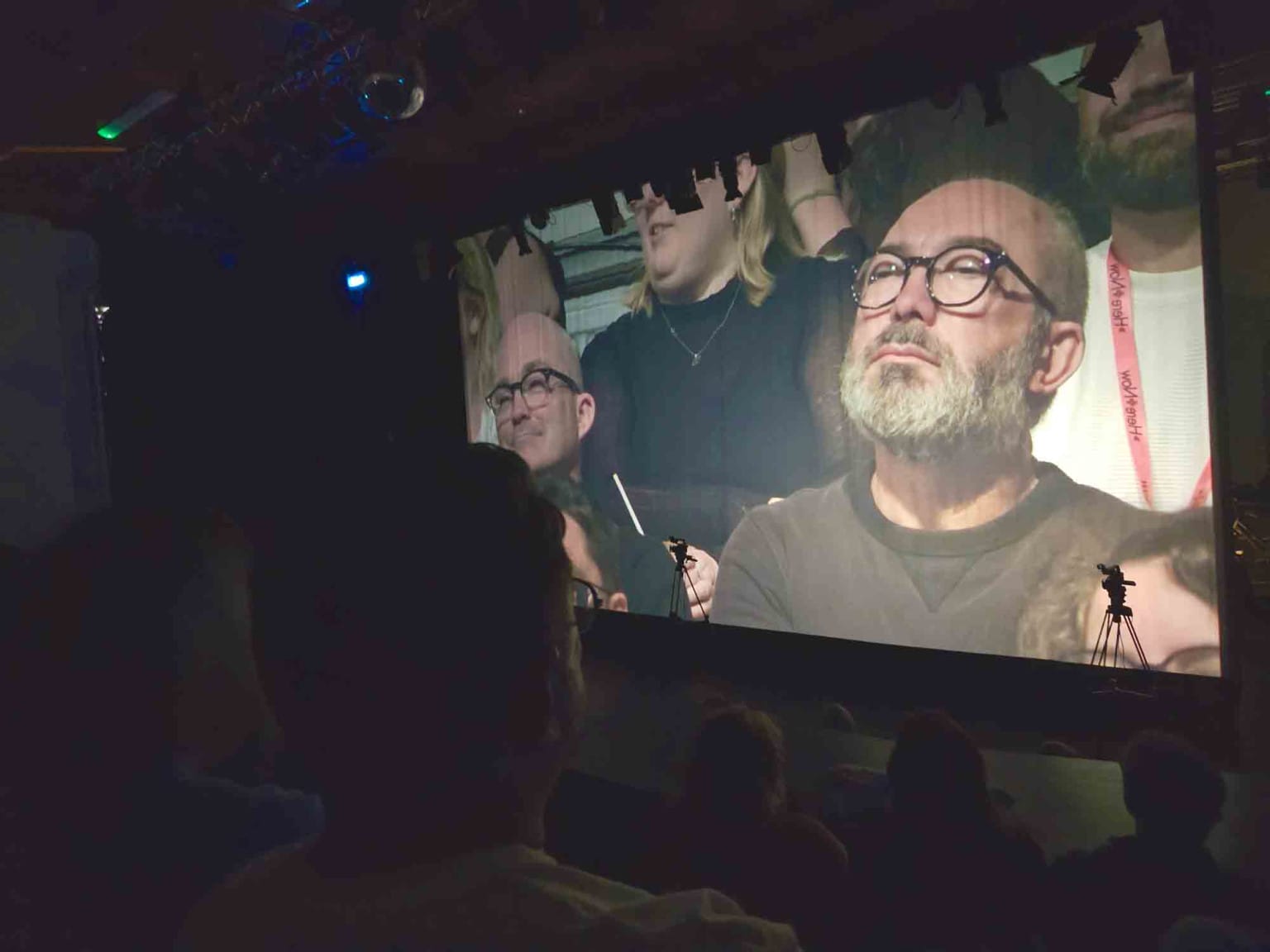 Michael's massive head, projected on a cinematic screen