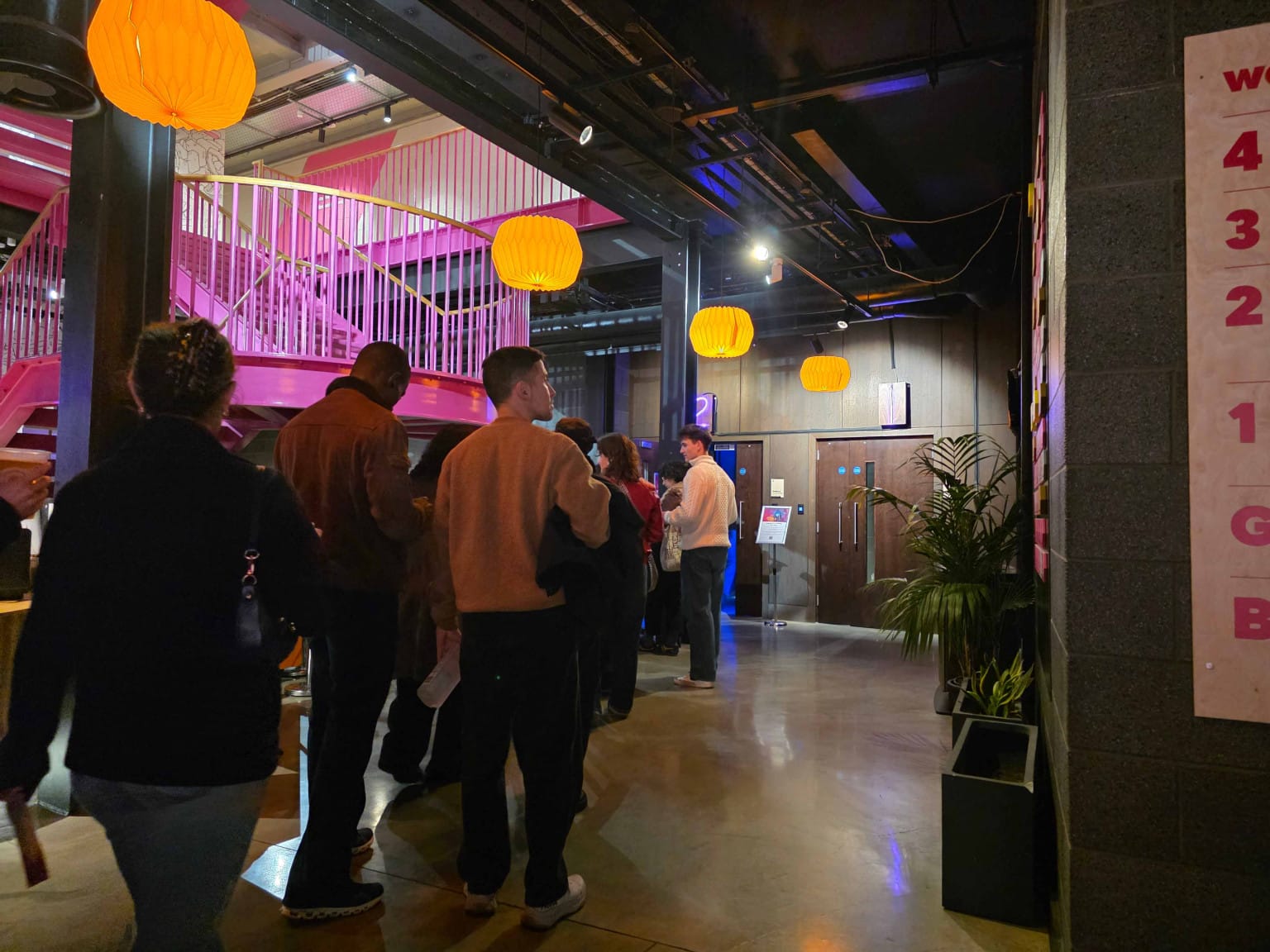 Excited audience members queuing for entry