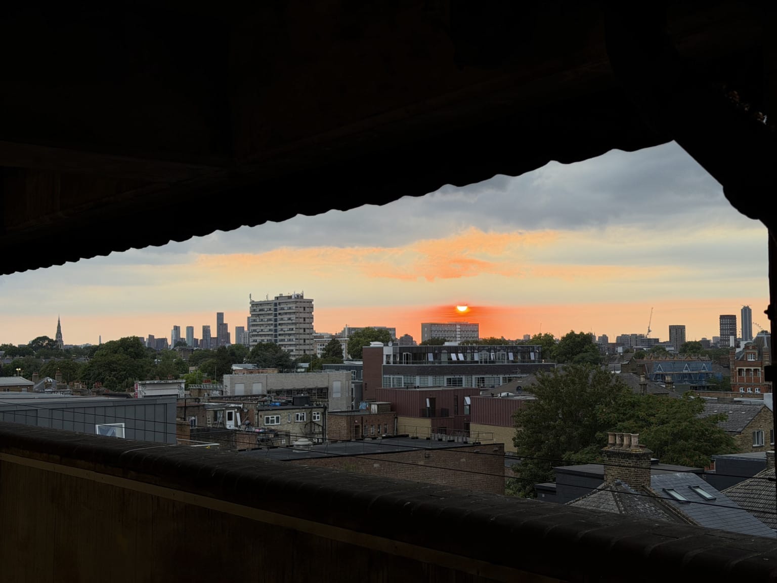 The sun setting in the haze from the venue